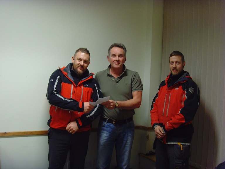 Volunteers from Dublin Wicklow Mountain Rescue receiving a donation from proceeds of the festival.